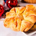 Homemade pastry stuffed with ham and with New Year decoration in the background