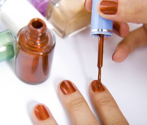 Brushing Nails With Red Nail Polish