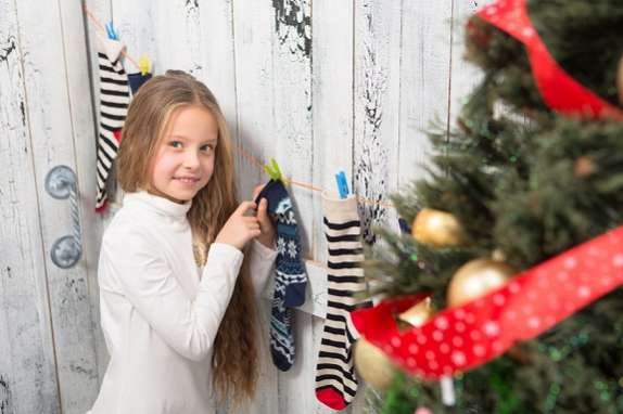 Teenage girl looking into New Year and Christmas socks